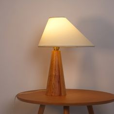 a wooden table with a lamp on it