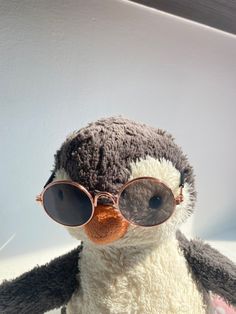 a stuffed penguin with sunglasses on it's face