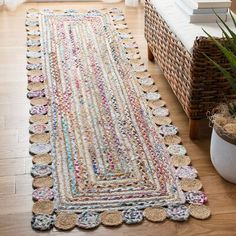 a large rug is on the floor next to a plant