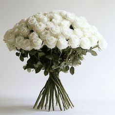 a bunch of white roses in a vase