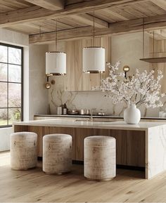 a kitchen with marble counter tops and stools in front of an island that has flowers on it