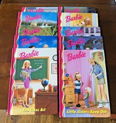 two barbie books are sitting on a table