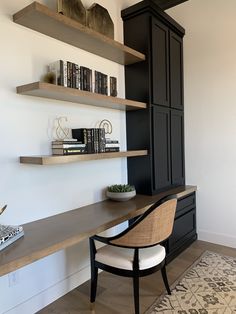 a chair sitting in front of a desk with bookshelves on top of it