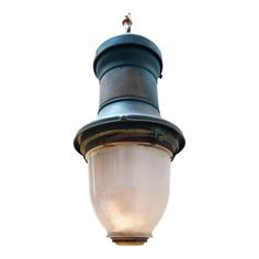 an old fashioned light hanging from the side of a lamp post against a white background