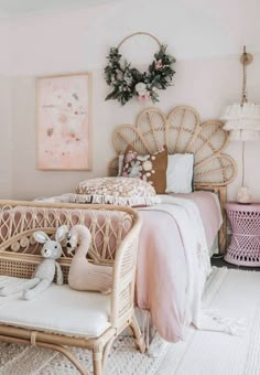 a bedroom decorated in pink and white with wicker furniture