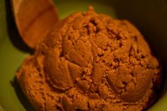 a green bowl filled with chocolate ice cream