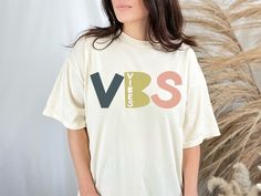 a woman wearing a t - shirt with the word vrs printed on it