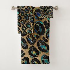 an animal print towel hanging on a wall