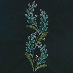 an embroidered piece of cloth with green and yellow flowers on it, against a black background