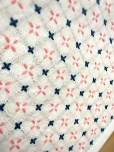 a close up view of the fabric on a table cloth with red, white and blue stars