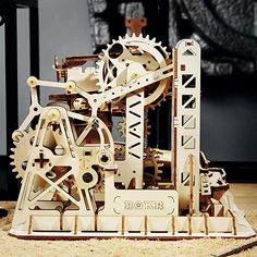 a clock made out of wooden gears on the floor