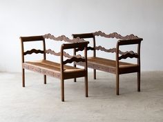 two wooden benches sitting next to each other