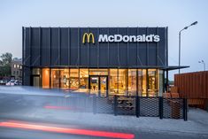 a mcdonald's restaurant with cars passing by