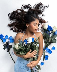 a beautiful woman holding flowers in her hands