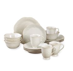 an assortment of white dishes and cups