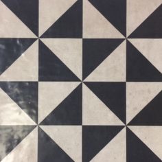 a black and white tiled floor with triangles