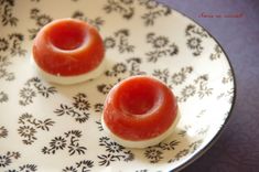 two small donuts on a plate with black and white designs