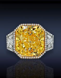 Jacob & Co. Three Stones Diamond Solitaire, Featuring: GIA Certified 13.00 Ct Fancy Intense Yellow, VS1, Radiant Cut Diamond, Flanked by 1.43 Ct Trapezoid Shape Diamonds (2 Side Stones), Surrounded by Pave' Set 1.25 Ct Round Brilliant Cut Diamonds, Mounted in Platinum & 18K Yellow Gold. Asscher Engagement Ring, Canary Diamond, Three Stone Diamond Ring, Three Stone Diamond, Wedding Rings Halo, Bling Rings, I Love Jewelry, Jewelry Rings Engagement