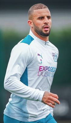 a man wearing blue shorts and a white shirt