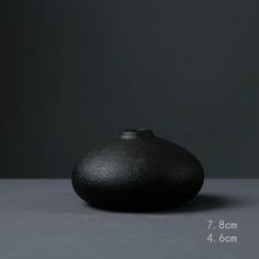 a black rock sitting on top of a table