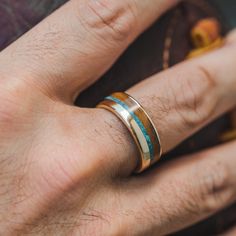 a man's hand with a ring on it