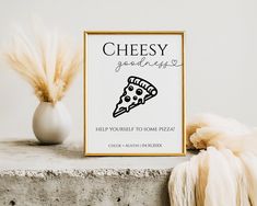 there is a sign that says cheesy goodies with a slice of pizza on it