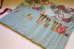 a blue bag filled with wooden utensils on top of a table