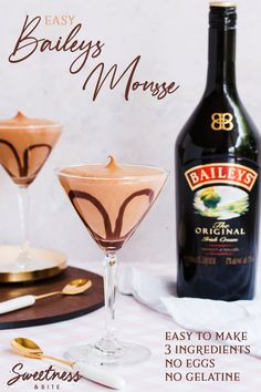 a bottle of bailey's mousse next to two glasses filled with chocolate