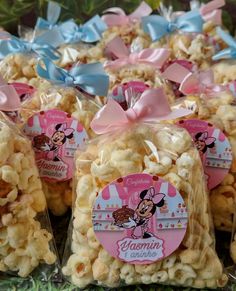 several bags of popcorn with minnie mouse tags on them