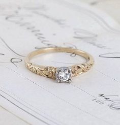 a diamond ring sitting on top of a piece of paper