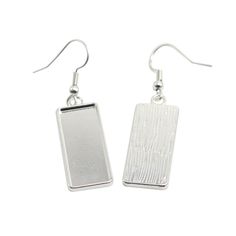 pair of silver earrings with rectangular shaped metal tags hanging from the end of each ear