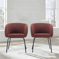 two red chairs sitting next to each other on top of a white carpeted floor