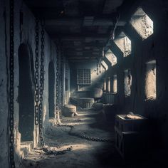 an abandoned building with chains hanging from the ceiling