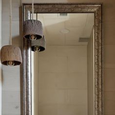 a bathroom mirror sitting next to a light fixture