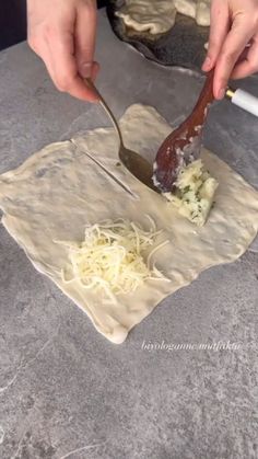 someone is cutting up some food on top of a piece of paper with a knife