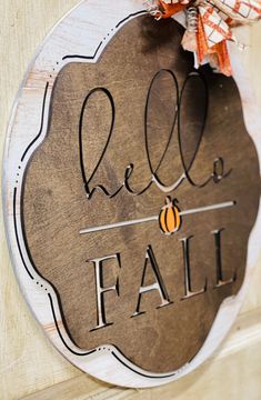 a sign that says relax and fall hanging on the side of a door with an orange ribbon