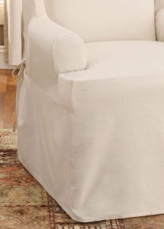 a white chair sitting on top of a rug