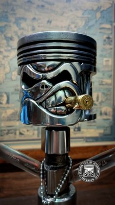 a motorcycle engine with a star wars helmet on it's head and chain around the neck