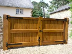 a large wooden gate in front of a house