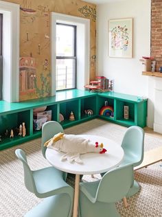 a child's playroom with green shelves and blue chairs