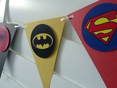 the batman and superman symbol are hanging on the wall next to each other in this room