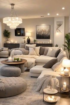 a living room filled with lots of furniture and candles on top of the coffee table