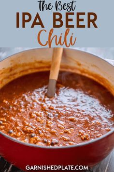 the best beer chilli recipe in a red pot with a wooden spoon sticking out of it