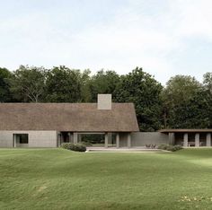 the house is surrounded by trees and grass