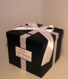 a black and white box with a ribbon on it