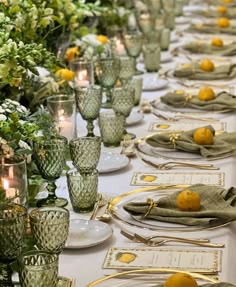 a long table is set with place settings and lemons