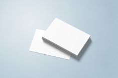 two blank white cards sitting on top of each other