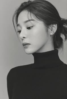 black and white photo of a woman in a turtle neck sweater