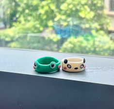 two bracelets sitting on top of a window sill