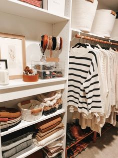 an organized closet with clothes and hats